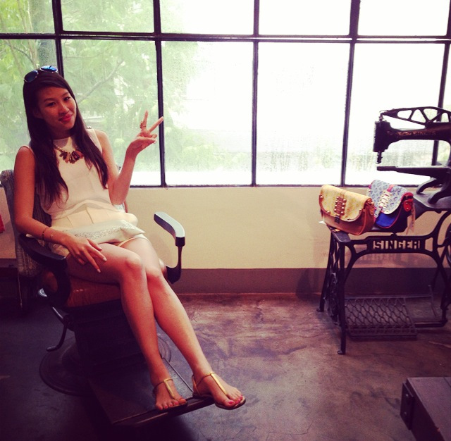 Sitting on props in L'usine's store on Dong Khoi Street, Ho Chi Minh, Vietnam.