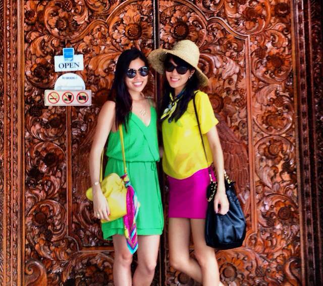 Posing in front of intricately wooden-carved doors leading to batik heaven at Bali Bidadari Batik.