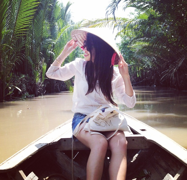 Sporting a nón lá on the short sampan ride back to our van. Mekong River, Vietnam. Ben Tre Day Tour.